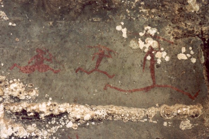A close up of the word " hell " written in red on a wall.